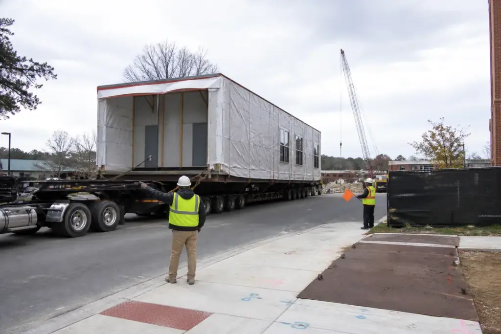 Warehouse leadership reviewing operations from a modular office
