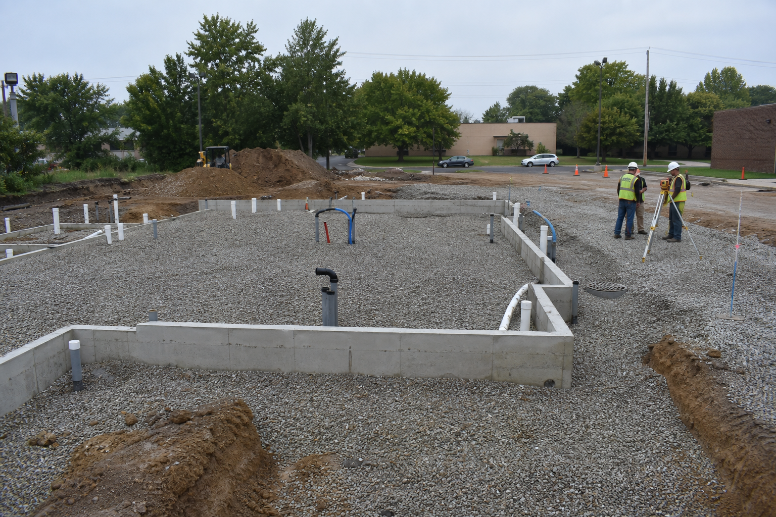 Prepared modular building foundations, utility stubs and survey work