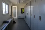 A practical locker room with changing benches and storage lockers