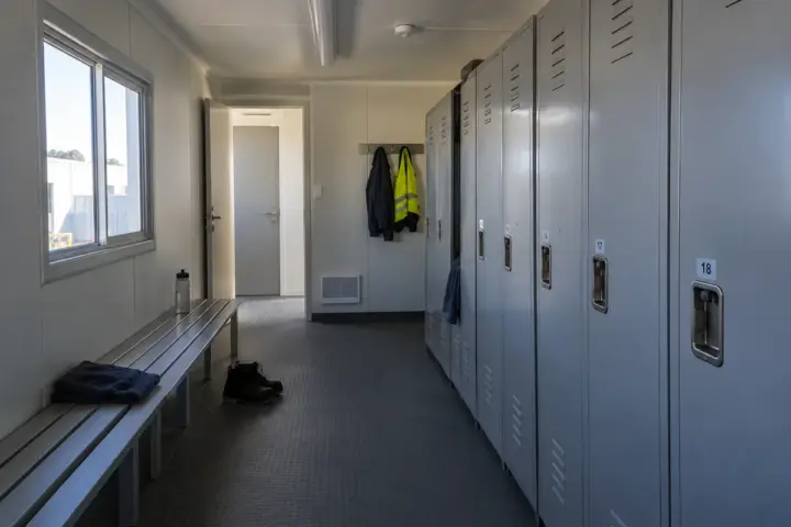 A practical locker room with changing benches and storage lockers