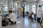 Technicians commissioning utilities and ventilation inside a modular laboratory
